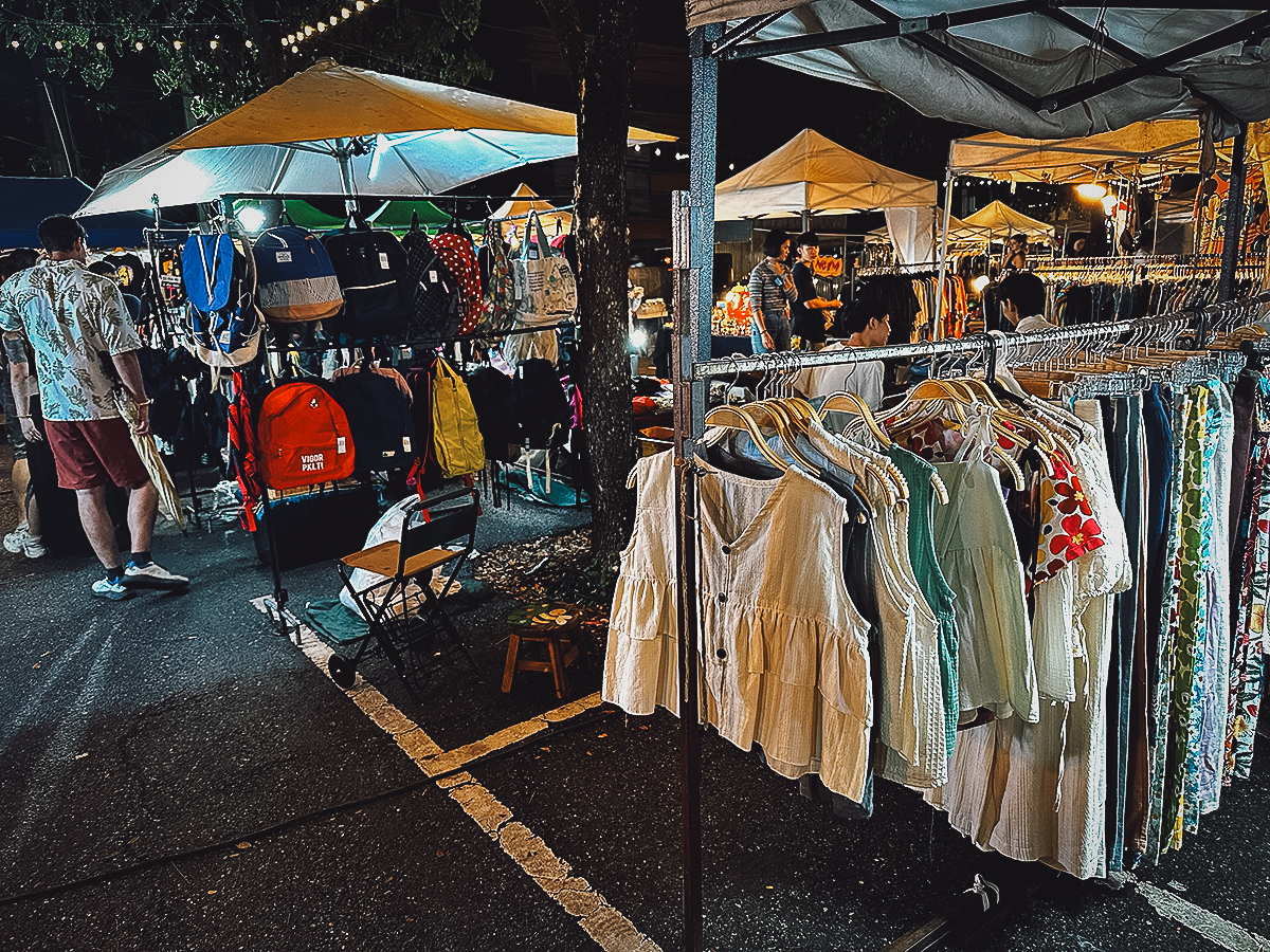 Clothing for sale at Night Ground Flea Market sign in Chiang Mai