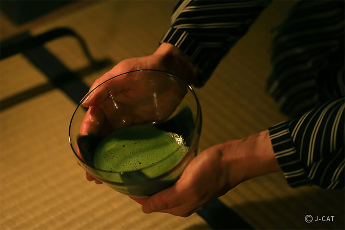 Man holding a bowl of matcha